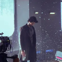 Behind the scenes on the Thums Up shoot with Vijay Deverakonda. This shot captures the calm before the storm, styling him in a dark, rugged trench coat for a dramatic snow scene.