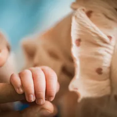 The unbreakable bond. A tiny hand wrapped around a parent's finger is a classic newborn photograph for a reason. It's a powerful symbol of connection and dependence.