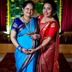 Two women sharing a happy moment at a maternity function. Capturing these connections between family and friends is a key part of my event photography service.