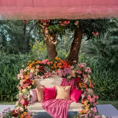 A beautiful floral throne for a Mehendi ceremony. The sofa is completely enveloped in a rainbow of fresh flowers, creating a breathtaking focal point and the perfect photo spot.