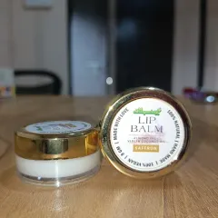 A close-up of our Saffron Lip Balm. It's made with almond oil, virgin coconut oil, and saffron. It is 100% vegan, natural, and handmade with love to care for your lips.