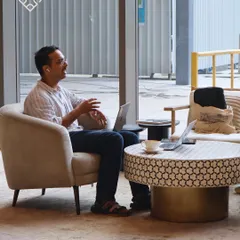 A customer takes a call in one of our comfy armchairs, laptop at the ready. Our space is designed for the flexibility modern work requires.