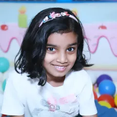 A sweet portrait of a girl in a colorful ball pit during a birthday party. Play areas at events are fantastic for capturing genuine smiles and playful photos.