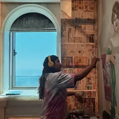 Here I am working on a custom portrait mural in a more classical style. This shows my versatility in handling different artistic themes, from modern pop art to traditional portraiture.