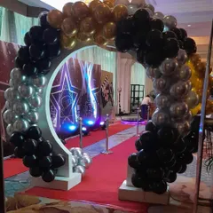 An impressive balloon arch entrance for a Hollywood-themed 18th birthday party, complete with a red carpet.