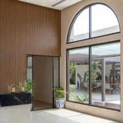 The arched windows are a key feature of the design, lending a touch of classic elegance to the modern workspace.