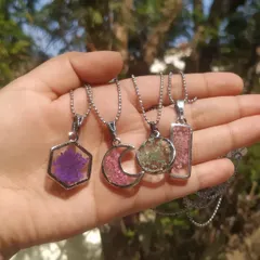 This is a small collection of my floral pendants. I can preserve tiny flowers in various shapes like hexagons, moons, circles, and rectangles, so you can carry a piece of nature with you.