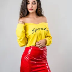 A vibrant fashion portrait inspired by the McDonald's color scheme. The model wears a bright yellow top and a shiny red skirt, creating a look that is playful, bold, and eye-catching.