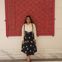 A fun, retro-inspired look with a floral skirt and suspenders over a classic white shirt. This shows how you can play with different styles for a unique everyday outfit.