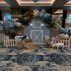 For Prahaan's second birthday, I brought a charming barnyard to life. This wide shot shows the complete farm-themed setup, featuring a custom-built barn backdrop, organic balloon garlands, and life-sized animal props that created an immersive experience for all the little guests.
