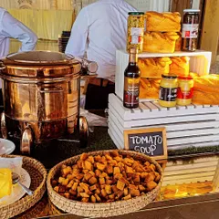 A comforting Tomato Soup station, complete with a traditional copper urn, croutons, and freshly baked bread. A classic choice for any event.
