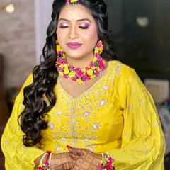 A serene, eyes-closed portrait that highlights the soft glam makeup and the freshness of the floral jewellery.