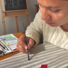 This is me, lost in the process of creating a color wheel. For me, painting is a form of meditation. It’s in these quiet moments of focus, with sunlight streaming through the window, that I feel most like myself.
