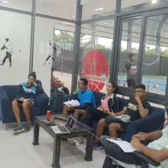 Another view of our athletes engaged in a mental conditioning workshop, taking notes and participating in discussions.