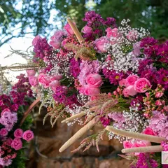 A lush arrangement of pink and purple flowers from our 'Pomegranate Spring' theme. The mix of roses, chrysanthemums, and baby's breath creates a rich texture and vibrant pop of color.