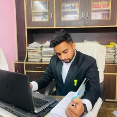 Working at my desk, surrounded by case files. This is where the strategy is built before ever stepping into the courtroom. Diligent preparation is key to success.
