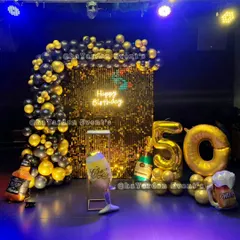 Another fantastic 50th birthday, this time with giant gold foil balloon numbers. The black and gold theme with a sequin backdrop is perfect for a big party bash.
