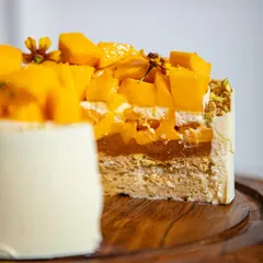 A close-up of the layers in our mango cake, showing the light sponge, mango compote, and fresh fruit. This is what makes our mango cake supreme.