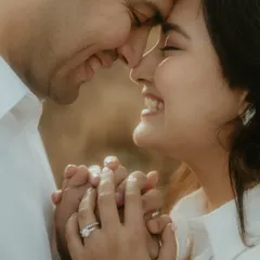 An intimate close-up of a couple, their faces close together, sharing a genuine, joyful smile. This shot focuses on the raw emotion and connection, capturing the essence of a candid couple portrait.