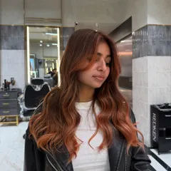 A dimensional ginger balayage perfect for autumn vibes. The warm, coppery tones are blended beautifully for a glowing, natural-looking finish.