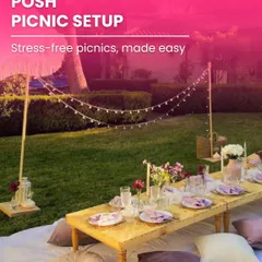 I turn simple picnics into posh, luxurious experiences. This setup features a low wooden table, plush floor cushions, elegant place settings, and string lights, creating a comfortable and stylish outdoor lounge for any celebration.