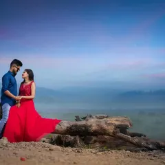A wide-angle shot of a couple against a beautiful, misty landscape at dusk. This pre-wedding photo captures a sense of romance and adventure, showcasing how I use epic scenery to create stunning portraits.
