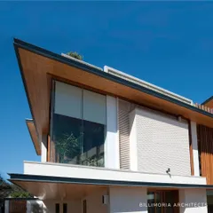 A key feature of our work is the use of angled, cantilevered roofs. This architectural element not only creates a signature look but also provides shade and frames the large glass windows that connect the interior to the sky.