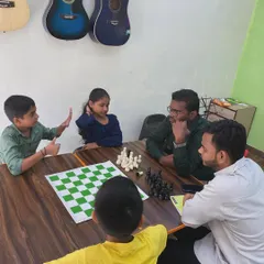 An interactive learning session at our chess class. My instructors and I work closely with students, discussing strategy and analyzing moves to deepen their understanding of the game.