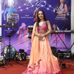 On stage at the Shakti Raas Utsav, an event I organized from the ground up. This photo captures the feeling of a successful show, standing in front of a banner that represents months of planning and passion.