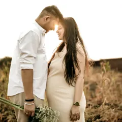 A stunning silhouette of the couple touching foreheads, with the golden sun flaring perfectly between them. This is the kind of magical, romantic shot that the golden hour is famous for.