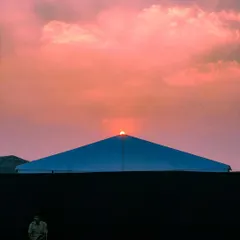 The same sunset scene behind a tent, this time edited with a soft, pink sky, creating a completely different mood.