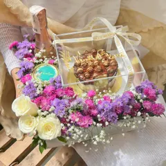 A top-down view of the luxurious Starlet Hamper, showing the balance of our rich chocolate bento cake, a mini champagne bottle, and a vibrant floral arrangement.