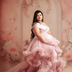This ruffled pink gown is a favorite among my clients. It brings so much texture and romance to a maternity portrait, especially against a soft, floral backdrop.