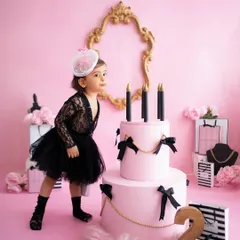 This little model has more sass at two than I've had my entire life! Her pose next to the cake in this chic pink and black setup is just iconic.