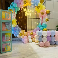 A popular and beautiful choice for welcoming your baby home. This full circular balloon arch in soft pastel colors, complete with a 'Welcome Baby' neon sign and transparent 'BABY' boxes, creates a warm and joyful atmosphere right in your living room.