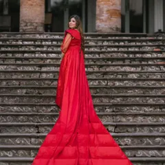A full view of the magnificent quilted trail on this red gown. The detachable sleeves have been removed here, showcasing a different style for this versatile rental piece.