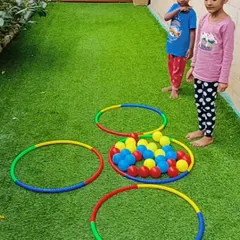 An outdoor game to learn about colors and shapes. The children have to sort the colored balls into the matching hula hoops, making learning a physical and fun activity.