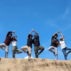 Finding strength and balance together. Our students get creative with a partner Tree Pose against a brilliant blue sky, showcasing the fun and collaborative spirit that defines our Hamsa tribe.