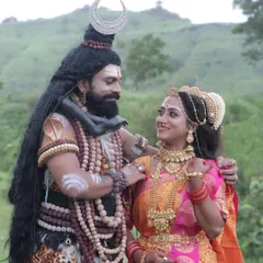A serene moment between the divine couple. This highlights the subtle expressions and the makeup's ability to convey emotion, a key skill in character artistry.