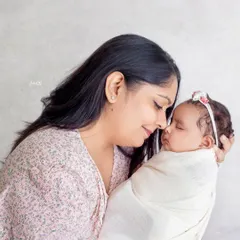 A mother's love is so powerful. This close up shot focuses on the tender connection between a mom and her brand new baby, a truly priceless moment.