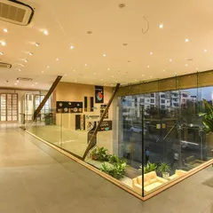 This view from the upper level of a commercial space shows how glass railings maintain an open, airy feel, connecting the different zones and allowing light to flow through the interior.