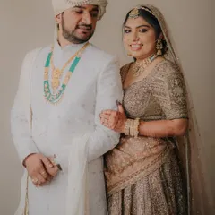 A classic portrait of the couple, Mahesh and Laxmi. The bride's embroidered lehenga and the groom's elegant sherwani are beautifully captured.