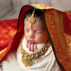 Blending tradition with the tenderness of new life. This portrait, inspired by Varamalakshmi Pooja, was a special request that allowed us to create something truly unique and meaningful, celebrating both heritage and a new beginning.