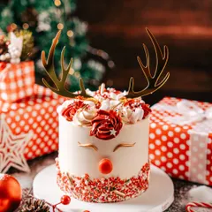 Our adorable Reindeer Mini Cake, complete with golden antlers and a red nose. This charming cake is a festive favorite, perfect for adding a touch of whimsy to your Christmas celebration.