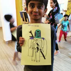 This young man is so proud of his Mandalorian drawing! We love seeing kids bring their favorite characters to life, mixing pop culture with our folktales for a truly creative session.