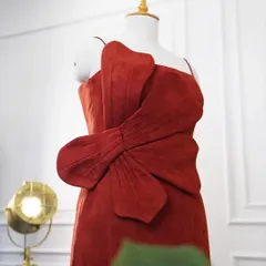 A close-up of the 3D statement flower on the red evening dress, highlighting the texture and craftsmanship of this standout detail.