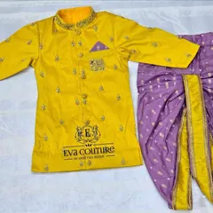 A similar sherwani set in a bright yellow. The embroidered kurta is paired with a purple printed dhoti, making it a great choice for a Haldi ceremony or other festive events.