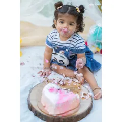 A first birthday isn't complete without a little bit of mess. This cake smash session was all about fun, as little Nitya enjoyed her very own birthday cake. These are the playful, personality-filled moments families cherish.
