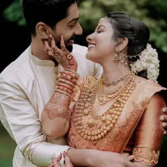 An intimate portrait of a couple, showcasing the deep connection and the intricate beauty of South Indian wedding attire and henna. I focus on capturing these quiet, heartfelt exchanges.