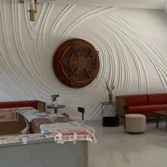 An in-progress view of the relief wall installation. The surrounding furniture is carefully covered as we work, showing how we integrate our process into an existing space with professionalism and care.